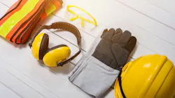 Standard construction safety equipment on wooden table. Standard construction safety equipment on white wooden background. safety first concepts