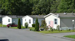 Mobile Home park. Park of mobile home community shown on this pictures. Three double wide trailers with one american flag on it