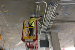 Guarantee Electrical Company electrician Spencer Vincent installs conduit supports at the Cardinal Glennon Children’s Hospital job site in St. Louis. The electrical box pictured was assembled off site at Guarantee’s prefabrication workshop, cutting install time on site by approximately eight hours.