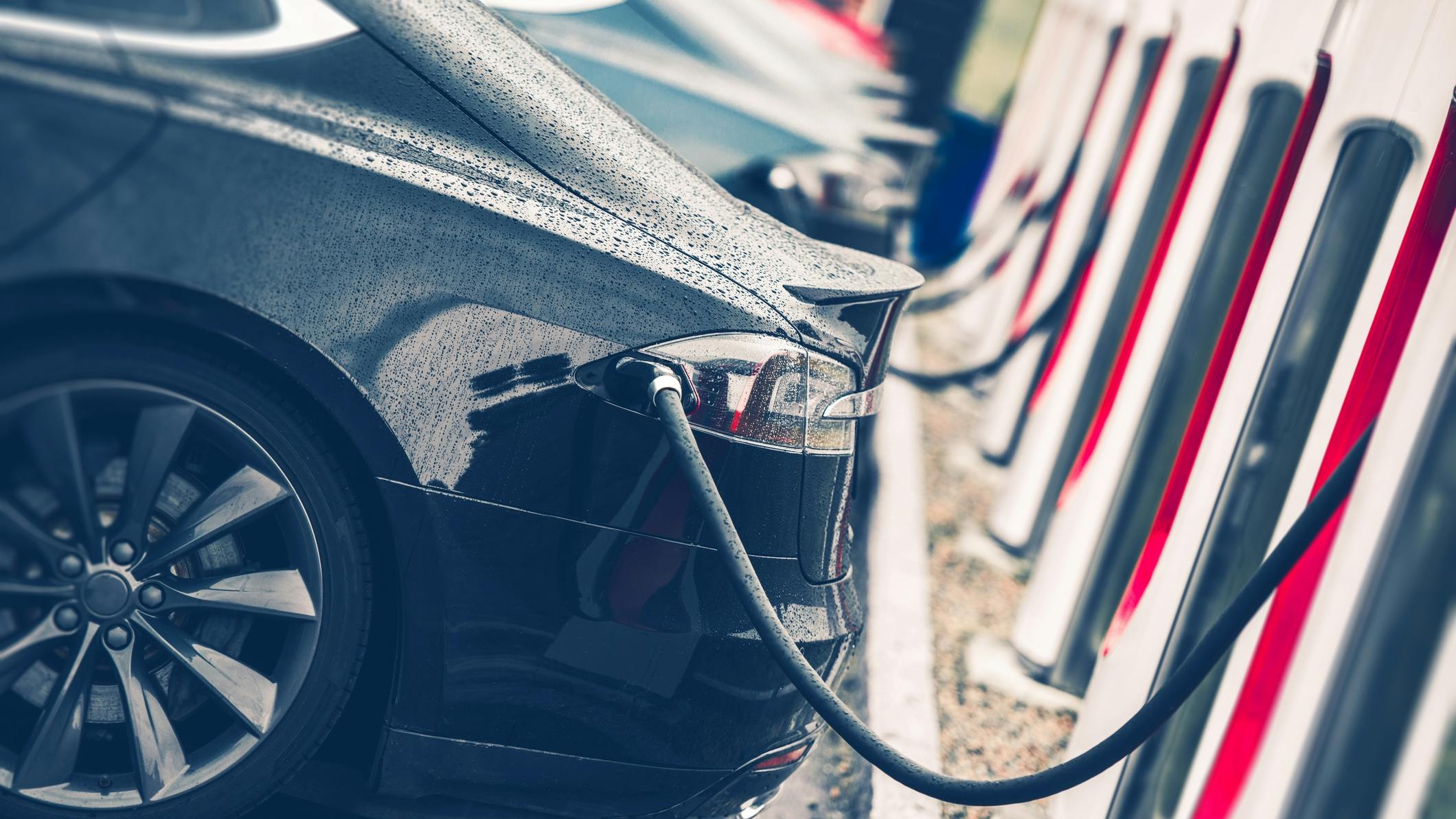 Electric Cars Charging Station Closeup Photo. Vehicle Rechargeable Batteries Charing. Future of Transportation.